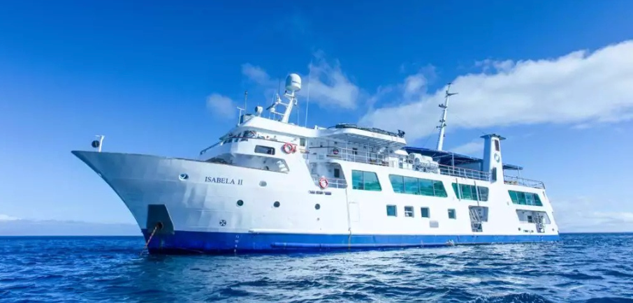 White passenger ferry named Isabela II sailing on calm blue sea under a clear sky, viewed from the bow side.
